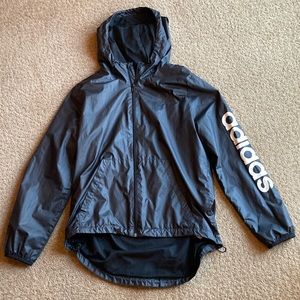 All black adidas windbreaker with Adidas spelled out on one arm
